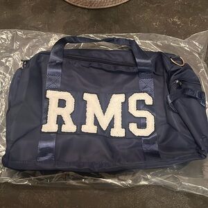 Judith March custom navy duffle bag.